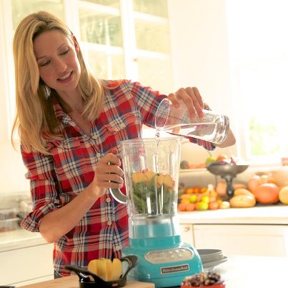 woman uses the blender kitchen
